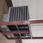 From below, the new unit on its frame, with supplyand return connections