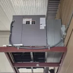 The new Bryant package unit installed on its overhead steel frame.